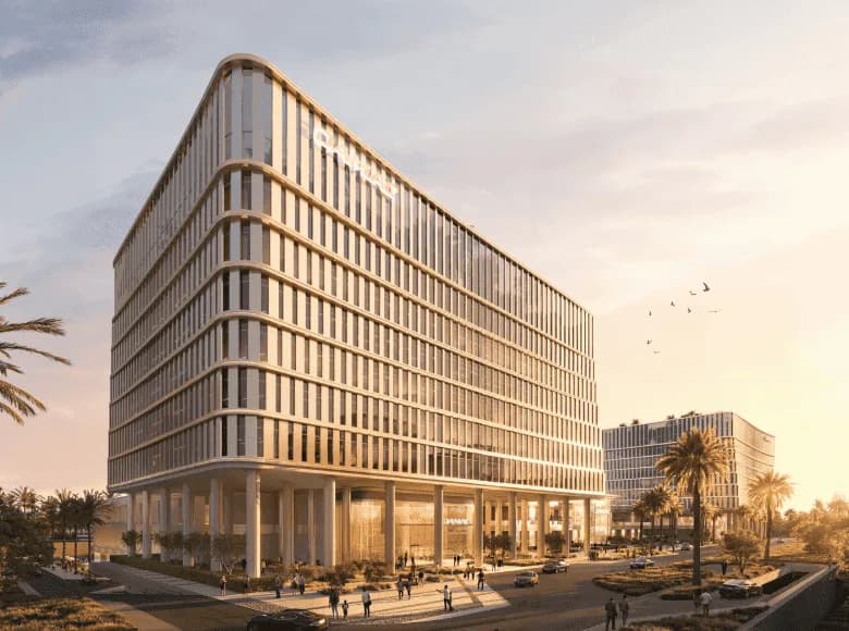 Piazza Roma at DAMAC Lagoons — glass office towers on a landscaped plaza at golden hour
